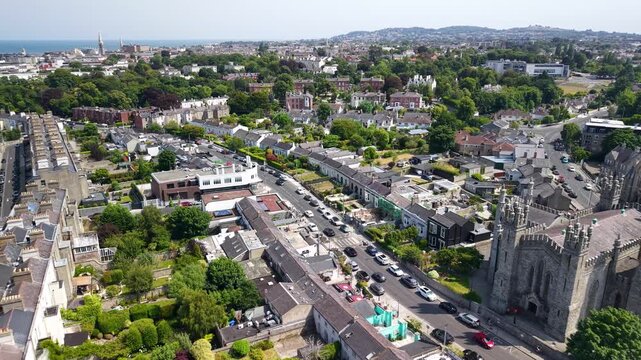 Monkstown Church building and Dun Laoghaire drone pull back with park and buildings. Ireland
