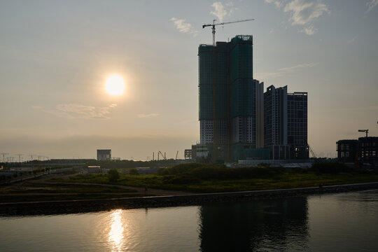 Morning sunlight over high-rise condominium construction site