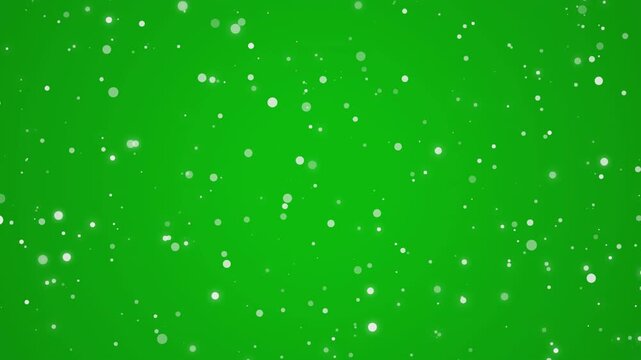 Abstract white particles animation for christmas winter overlay on chroma key green screen background for holiday season, seamless loop.