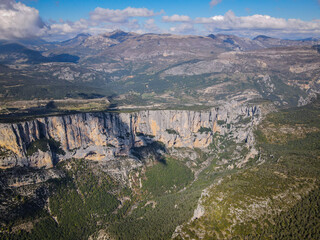 Fototapeta premium Aerial view of the dramatic limestone cliffs and forested slopes of Verdon Gorge, Provence, France