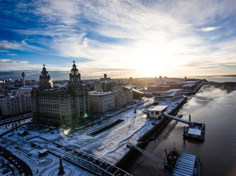 Liverpool winter snow at sunrise / Liverpool waterfront, Pier head and River Mersey covered in winter snow
