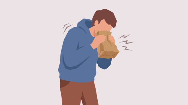 Person Hyperventilating Into Paper Bag