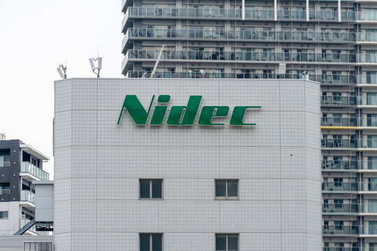 SHINAGAWA, TOKYO, JAPAN - JULY 31, 2026: A distant view of the green Nidec corporate logo signage on the upper wall of Tokyo Osaki Building in Shinagawa-ku, Tokyo.