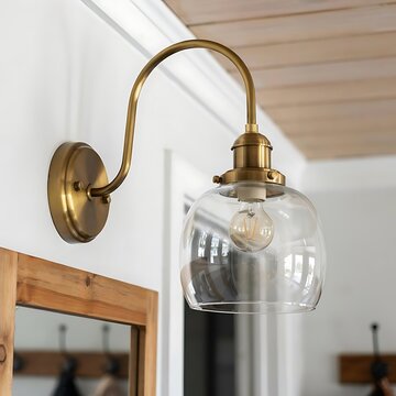 Modern rustic wall light fixture in antique brass and clear glass globe with lighting