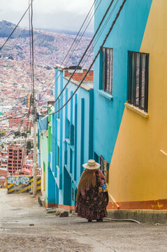 Woman in traditional dress on a colorful street in La Paz, Bolivia