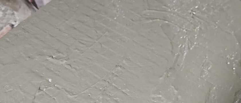 freshly applied wet cement mortar slurry on floor. Target audience includes building contractors, interior renovation designers, masonry suppliers, architectural public