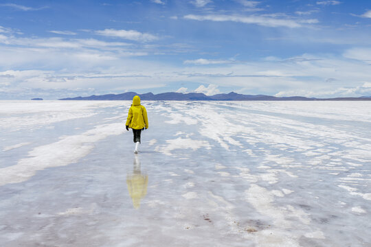 Traveller walking a salt path on the Salar de Uyuni, Bolivia