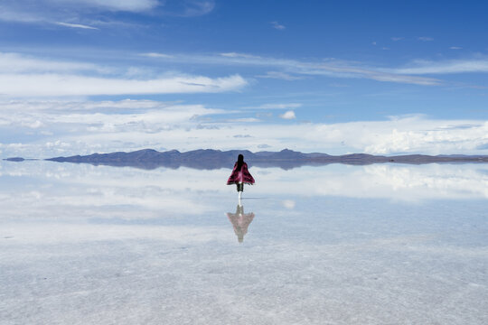 Woman in a purple poncho on the Salar de Uyuni, Bolivia