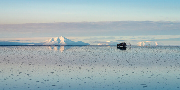 Volcano reflected on the flooded Salar de Uyuni, Bolivia