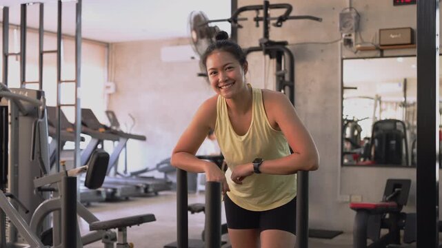 Hyrox race indoor looking at camera smile relax sport active asia people young Gen Z woman self care club. Girl power cross full core body cardio class muscle weight loss anti aging modern gym living