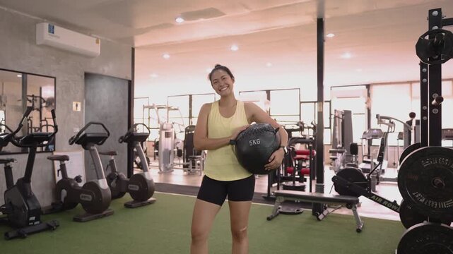 Hyrox race indoor looking at camera smile relax sport active asia people young Gen Z woman self care club. Girl power cross full core body cardio class muscle weight loss anti aging modern gym living