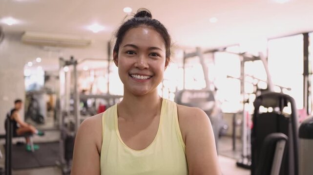 Hyrox race indoor looking at camera smile relax sport active asia people young Gen Z woman self care club. Girl power cross full core body cardio class muscle weight loss anti aging modern gym living