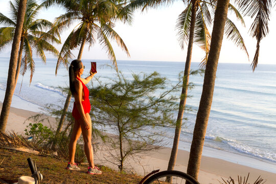 Woman with red swimsuit relax on beach