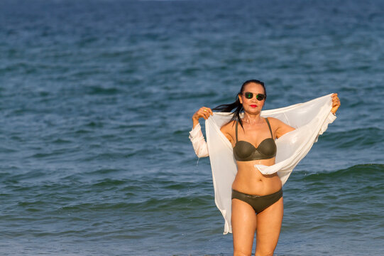 Woman in brown bikini show body pretty