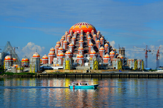 The 99 Domes Mosque in Makassar is a modern religious tourism landmark renowned for its unique architecture, vibrant colors, and seaside location.