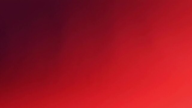 Abstract background with a smooth gradient transition from deep dark purple to vibrant bright red, creating a soft and warm atmosphere