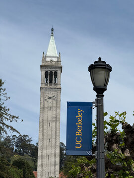 Sather Tower rises beside a UC Berkeley banner and streetlamp on campus - Berkeley, California, USA - April 18, 2026