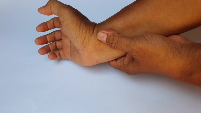 Close up of a person performing wrist flexion and extension stretching exercises to relieve joints pain, numbness, and carpal tunnel syndrome symptoms.