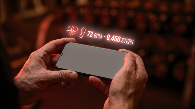 Futuristic health tracking app interface on smartphone. Digital heart rate and step counter hologram. Mobile fitness monitoring technology.