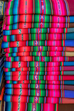 Vertical textiles pile on Tarabuco market, Sucre, Bolivia.