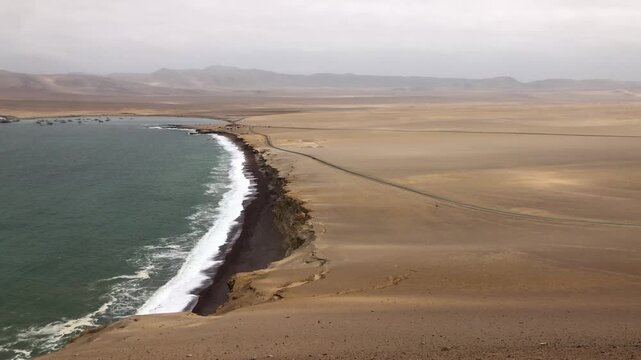 Dramatic coastal desert landscape meeting the ocean in peru