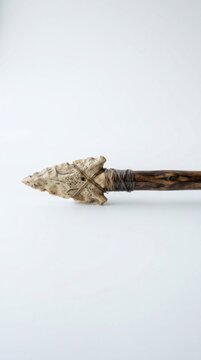 Ancient Stone Arrowhead Attached to a Wooden Shaft.