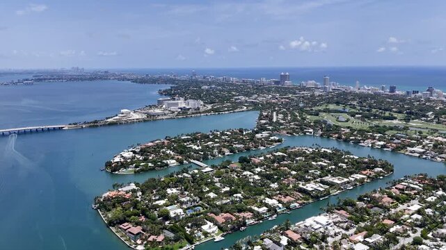 Aerial view of Miami skyline and waterfront islands over turquoise Biscayne Bay in sunny Florida, USA. g.