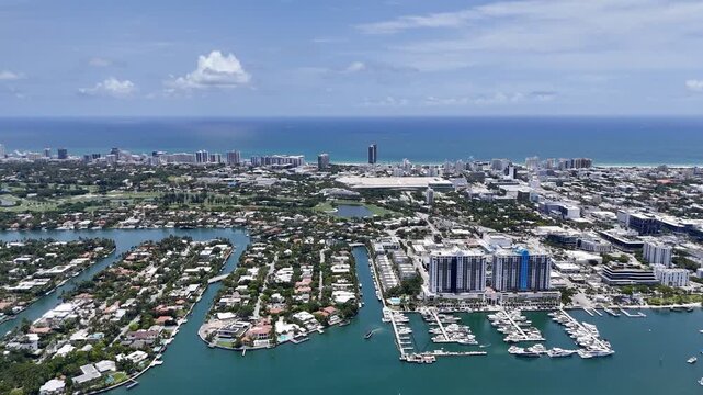 Aerial view of Miami skyline and waterfront islands over turquoise Biscayne Bay in sunny Florida, USA. g.