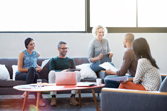 Creative, team and meeting in office with documents, advertising proposal and project collaboration. Happy, people and marketing strategy in agency with campaign manager, paperwork and productivity.