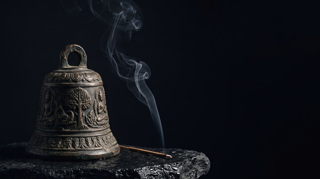 Antique Carved Bronze Temple Bell with Burning Incense Smoke on Stone