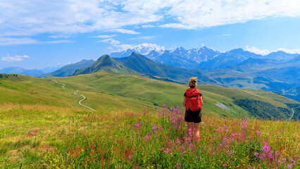 Fototapeta premium Woman Hiker Standing in Alpine Meadow Enjoying Alps Mountain View, Mont blanc, France in summer