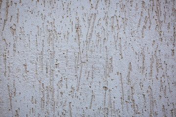 Fototapeta premium White Plaster Wall Texture with a Rough Scratched Relief Surface