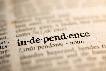 Fototapeta premium Understanding the profound concept of independence, this dictionary close-up highlights the essential meaning of freedom, self-reliance, and autonomy, crucial for empowerment