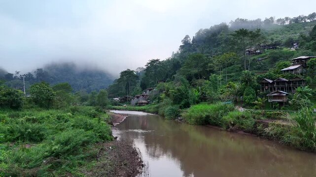 Aerial video showing mountains and morning mist in a rural village in Nan Province, northern Thailand.
