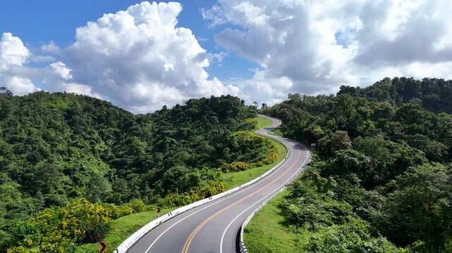Aerial view of car driving on beautiful steep curved road (look like number 3) on the high mountain in Nan province, Thailand.
