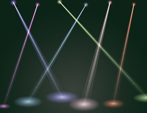 Colorful concert stage spotlights intersecting on dark background