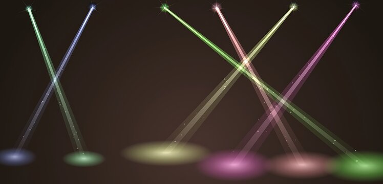 Colorful concert spotlights crossing light beams on dark background