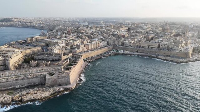fort st elmo aerial view marsamxett harbour ships distant golden hour valletta malta warm evening light coastal fortification peninsula star fort internationally recognized heritage site 16th century