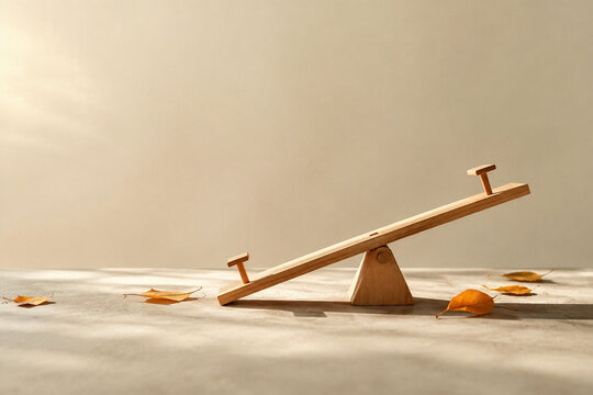 Tiny tilted wooden seesaw model with scattered autumn leaves, balance and prepared practical concept.
