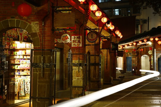 Light trails pass through historic Shenkeng Old Street at night.