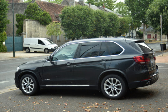 St- Amand Montrond - France - 5 August 2026 - black BMW X1 xDrive20d compact SUV parked on a city street, showing its rear three quarter view