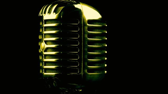 Classic gold microphone rotates slowly on dark stage with soft light