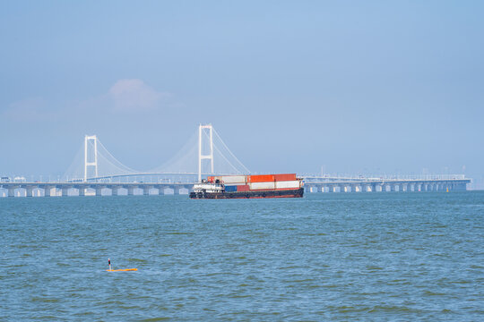 A container ship passing beneath the cross-sea bridge of China's Shenzhen-Zhongshan Link.