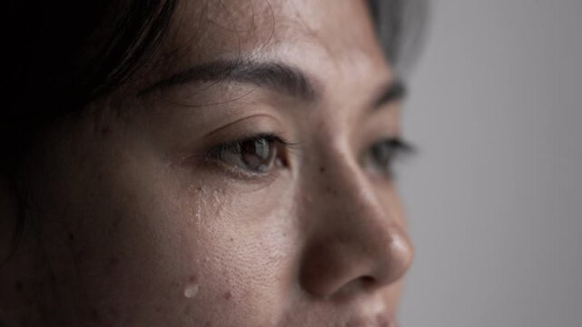 Depressed woman crying alone, showing emotional pain from family conflict, abuse, stress, trauma, loneliness, and difficult life problems. Mental health and support concept.