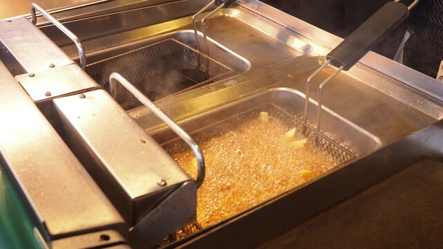 Frying food in a kitchen during busy lunch hours