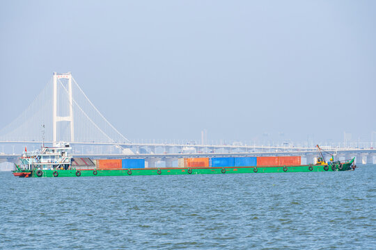 A container ship passing beneath the cross-sea bridge of China's Shenzhen-Zhongshan Link.