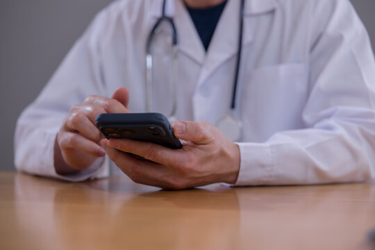 Mobile healthcare healthcare technology and connected care Doctor using smartphone to access patient information in a modern clinic