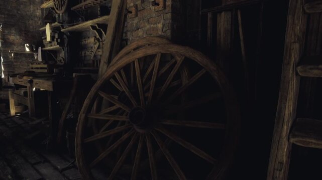 Closeup carriage wheel with weathered spokes and grainy rim deep shadows and patina reveal age, decay and tactile wood texture inside quiet loft space.