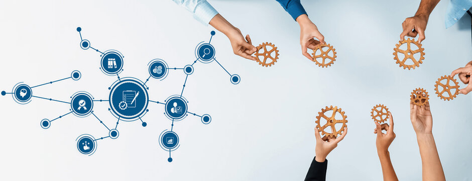 This image showcases a collaborative business scene with hands holding gears, symbolizing teamwork and process optimization for innovative management solutions. Amity