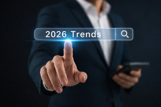 Businessman touching a virtual search bar displaying 2026 trends, symbolizing future business direction, technological innovation, and digital transformation for growth strategy and success.